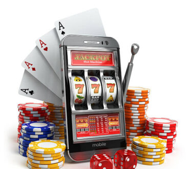 Online casino concept. Mobile phone, slot machine, dice and cards. 3d