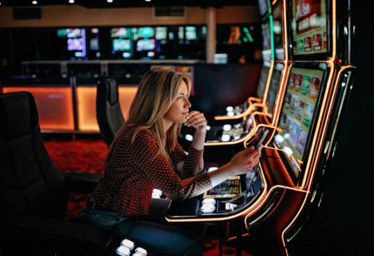Women gambling on slot machinery