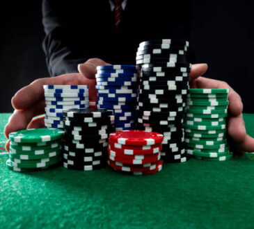 Businessman hands pushing gambling chips.