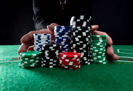 Businessman hands pushing gambling chips.