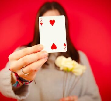 free-photo-of-woman-holding-a-two-of-hearts-card