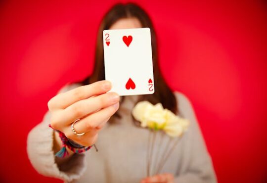 free-photo-of-woman-holding-a-two-of-hearts-card