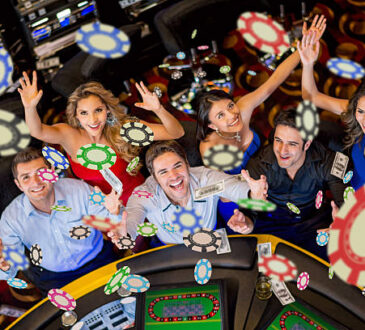 Happy group of people winning at the casino