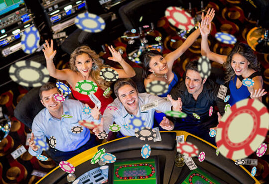 Happy group of people winning at the casino