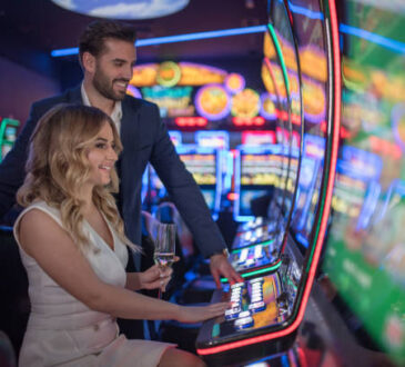 handsome couple having fun and drinking wine at casino