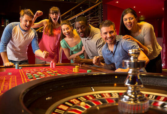 Group Of Friends Playing Roulette In Casino